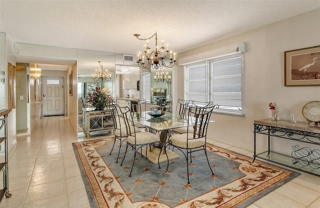 19 Whispering Sands Dr Unit 301, Sarasota, FL 34242 - dining space with a chandelier, light tile patterned flooring, and a textured ceiling