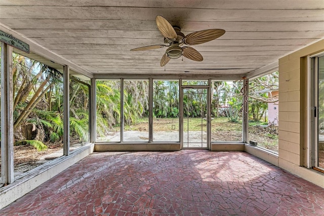 unfurnished sunroom featuring ceiling fan