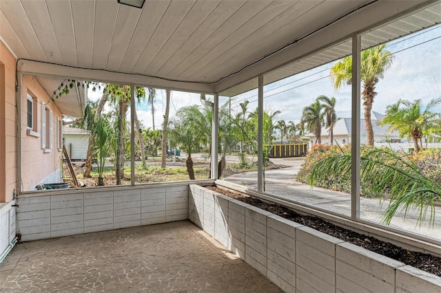 unfurnished sunroom featuring wood ceiling