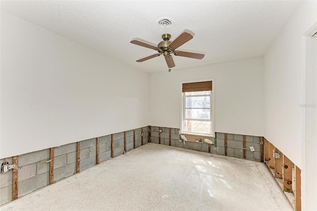 spare room featuring a textured ceiling and ceiling fan