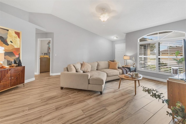 living room featuring vaulted ceiling and light wood-type flooring