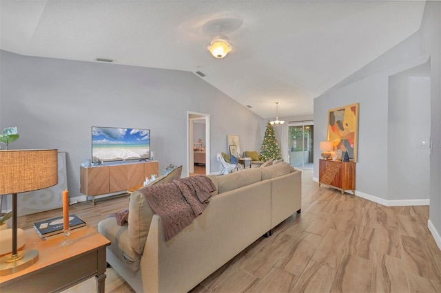 living room with light hardwood / wood-style flooring, vaulted ceiling, and an inviting chandelier