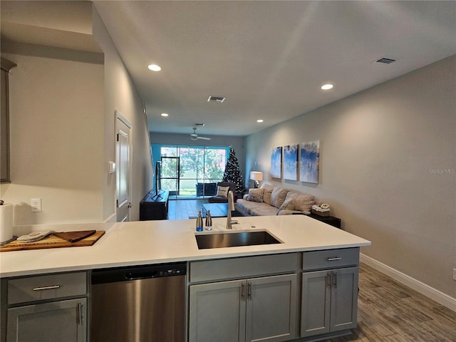 kitchen featuring stainless steel dishwasher, ceiling fan, gray cabinetry, and sink