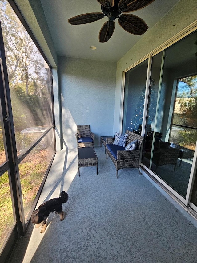 sunroom / solarium with ceiling fan and a healthy amount of sunlight