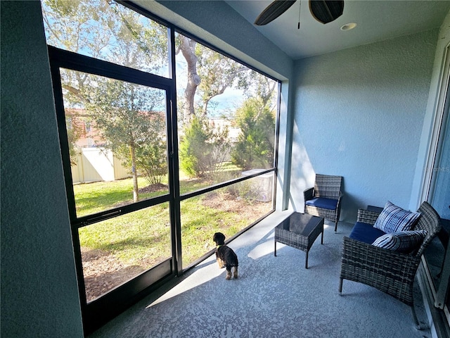 sunroom / solarium with ceiling fan and a healthy amount of sunlight