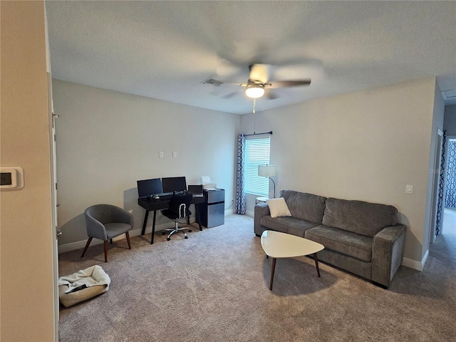 carpeted living room with ceiling fan and a textured ceiling