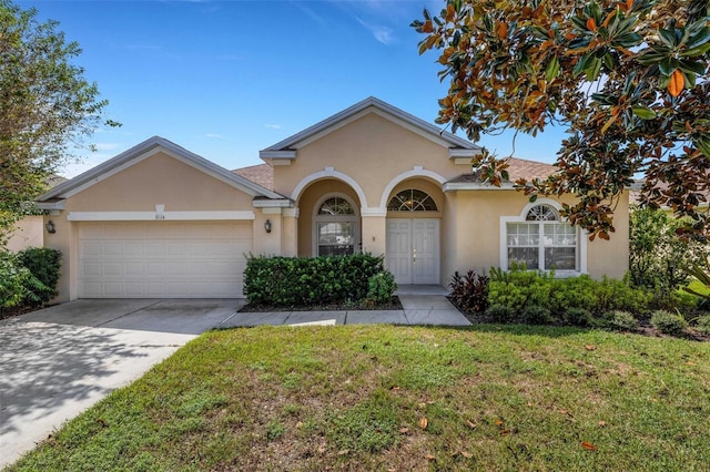 view of front of property with a front yard and a garage