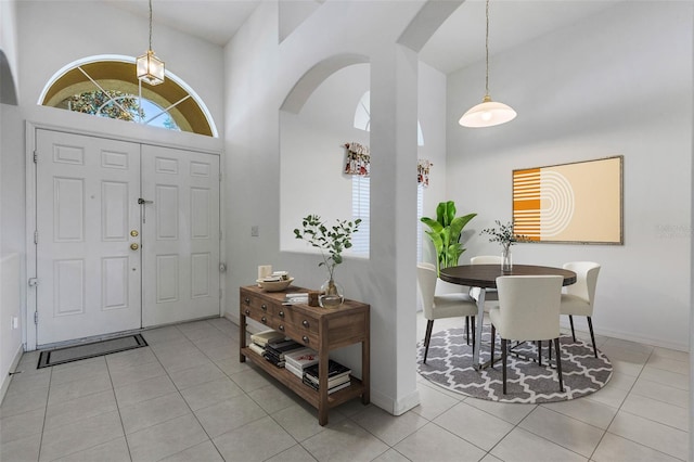 tiled foyer entrance featuring a high ceiling