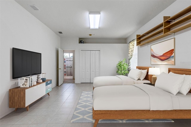 tiled bedroom with a closet