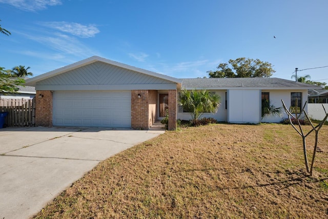 ranch-style home with a garage and a front yard