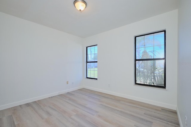 empty room featuring plenty of natural light and light hardwood / wood-style flooring