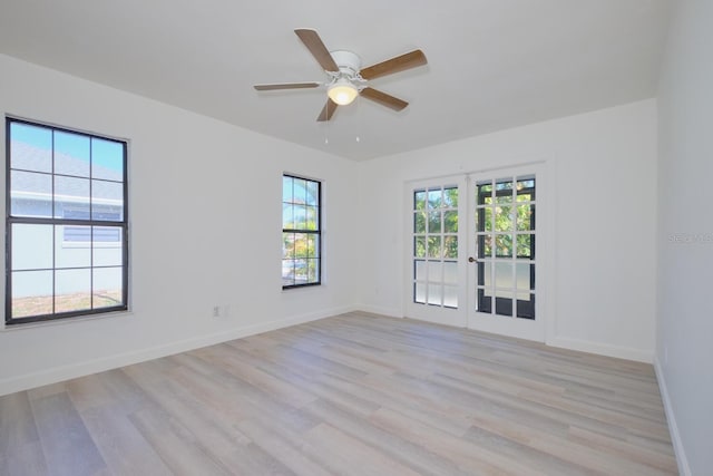 empty room with ceiling fan and light wood-type flooring