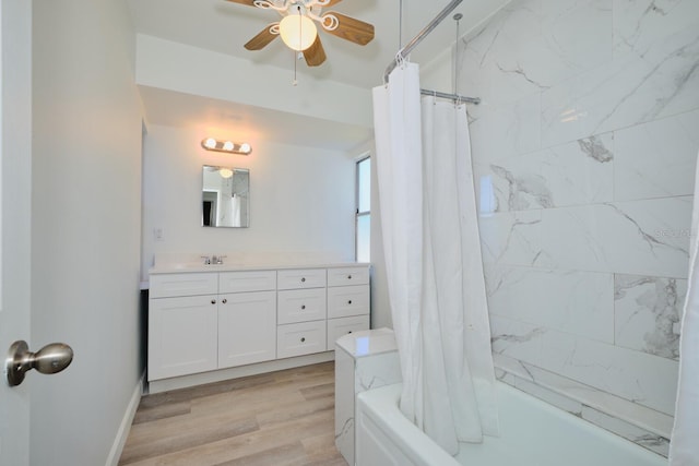 bathroom with shower / tub combo, vanity, hardwood / wood-style flooring, and ceiling fan