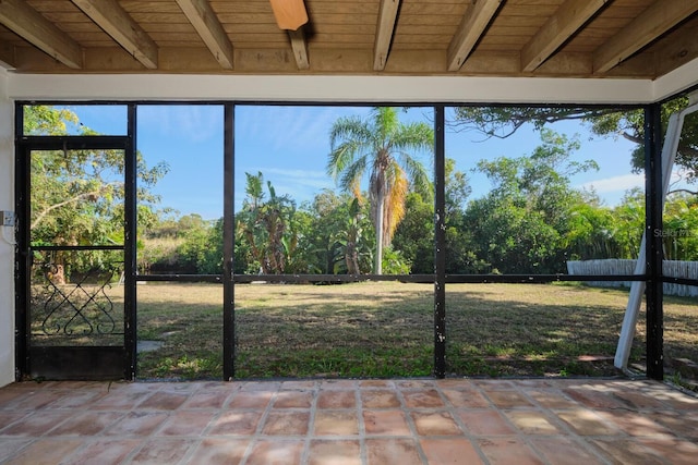 unfurnished sunroom with beamed ceiling and wooden ceiling