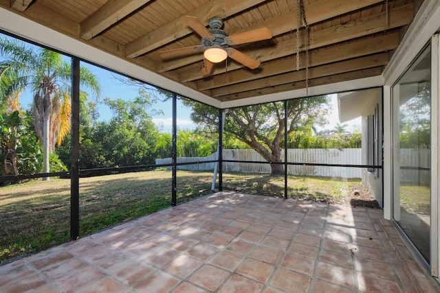 unfurnished sunroom featuring beamed ceiling and wooden ceiling