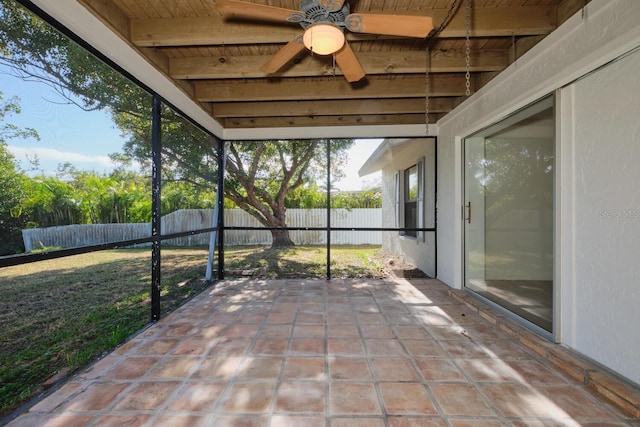 unfurnished sunroom with beamed ceiling and wooden ceiling