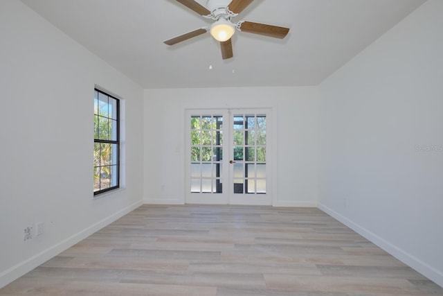 spare room featuring ceiling fan, light hardwood / wood-style flooring, and french doors