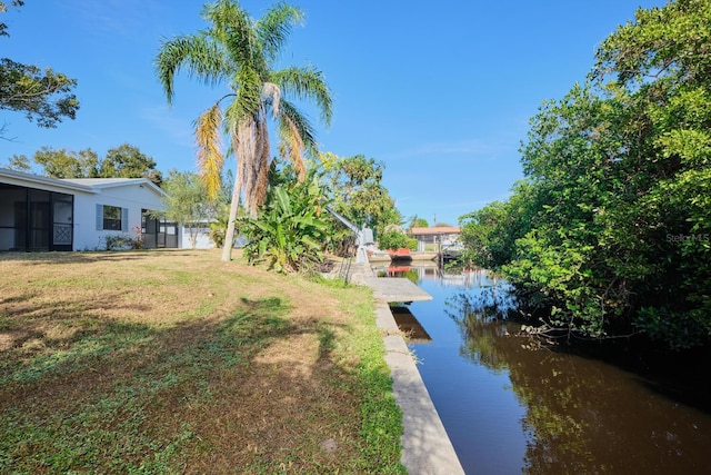 view of yard featuring a boat dock and a water view