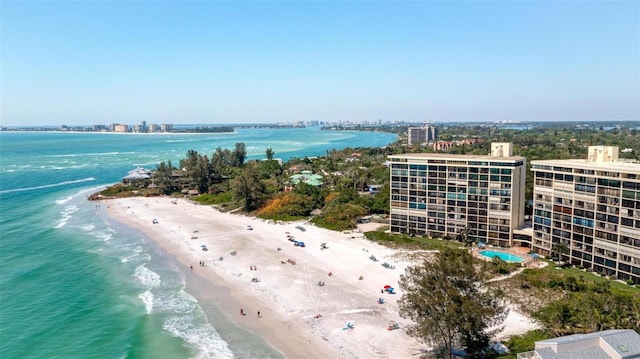 drone / aerial view featuring a water view and a beach view