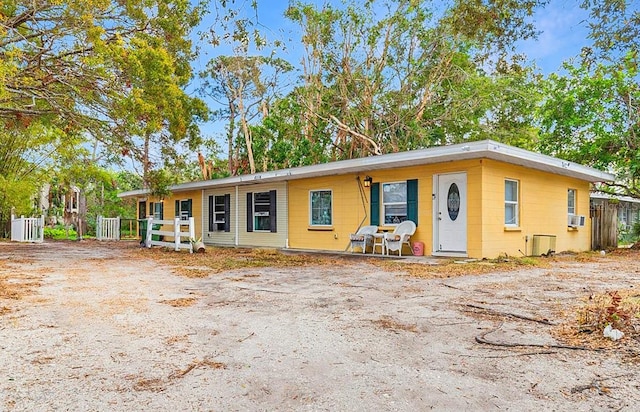 ranch-style home with cooling unit