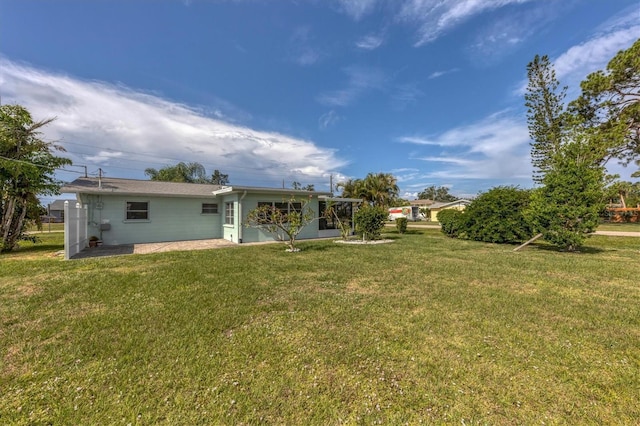 back of property featuring a yard and a patio area