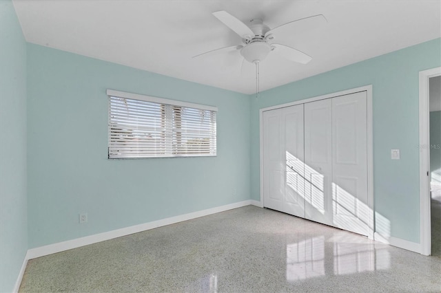 unfurnished bedroom featuring ceiling fan and a closet