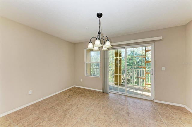 unfurnished dining area with a chandelier