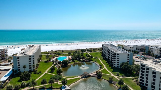 bird's eye view featuring a water view and a beach view