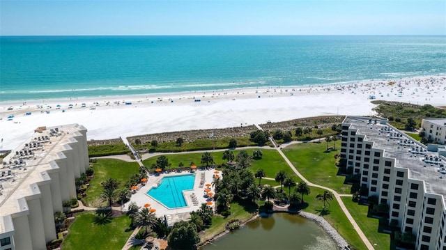 drone / aerial view featuring a beach view and a water view