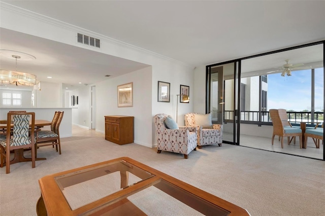 living room featuring ceiling fan, light colored carpet, and crown molding