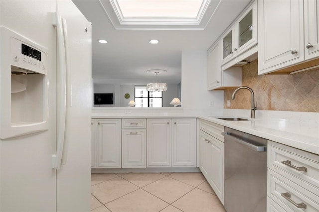 kitchen featuring dishwasher, white cabinets, pendant lighting, and white refrigerator with ice dispenser