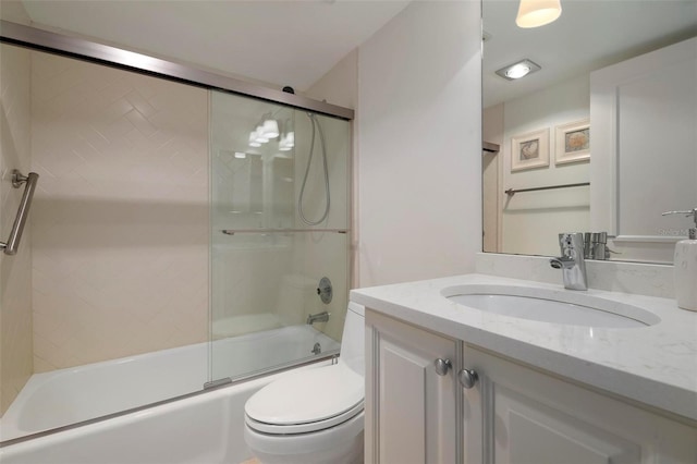 full bathroom with vanity, toilet, and enclosed tub / shower combo