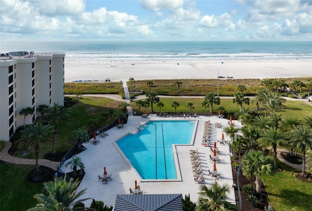 view of swimming pool featuring a beach view and a water view