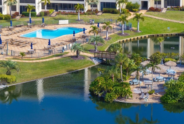 view of swimming pool with a water view and a yard