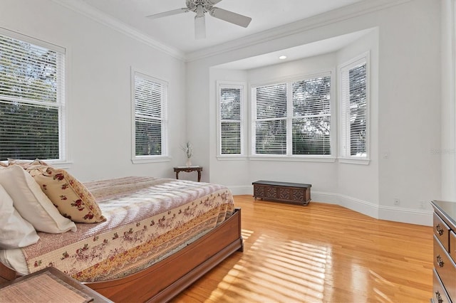 bedroom featuring ceiling fan, ornamental molding, and hardwood / wood-style flooring