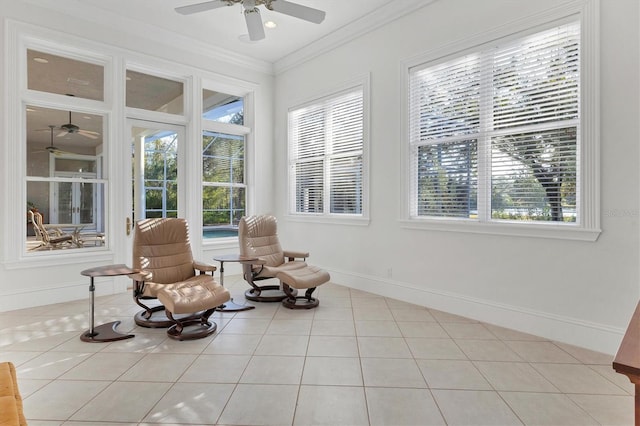 sitting room featuring ceiling fan, light tile patterned floors, and crown molding