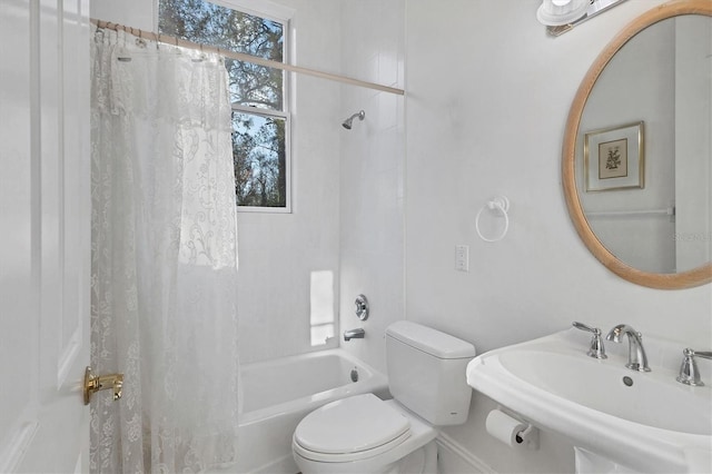 full bathroom with shower / bath combo with shower curtain, sink, and toilet