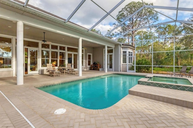 view of pool with an in ground hot tub, a patio area, a lanai, and ceiling fan