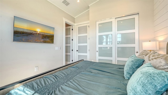 bedroom with vaulted ceiling and a closet