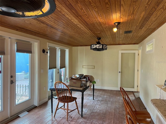 dining space with wood ceiling and wood-type flooring