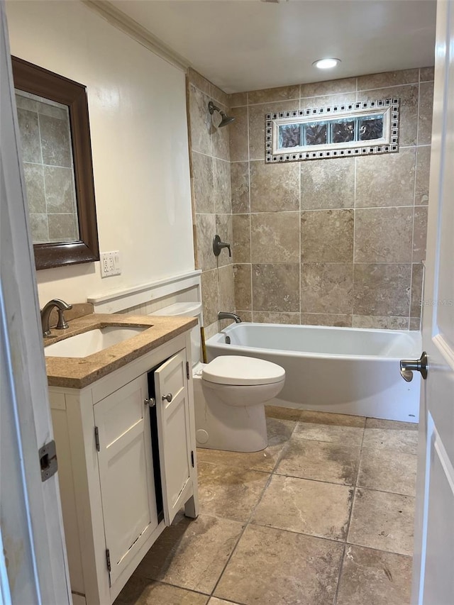 full bathroom with toilet, vanity, crown molding, and tiled shower / bath