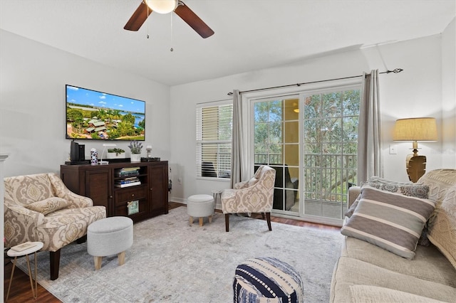 living room featuring ceiling fan and wood-type flooring