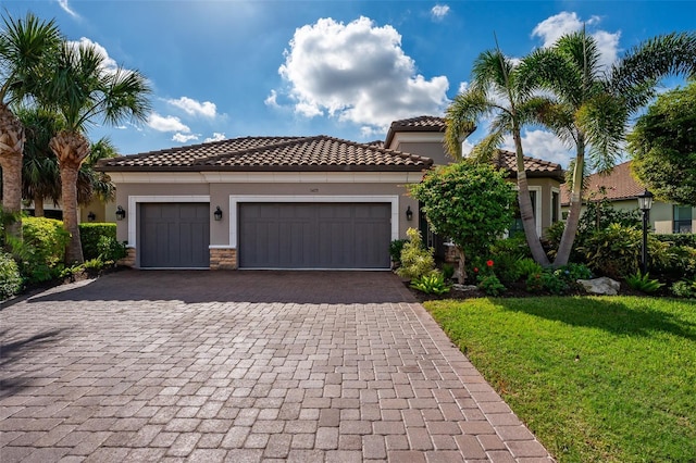 mediterranean / spanish-style house with a front lawn and a garage