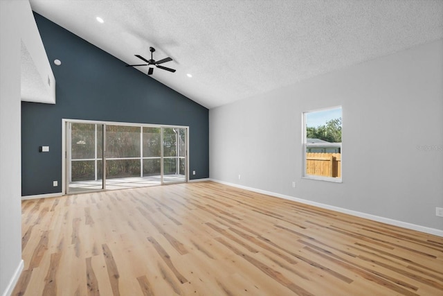 unfurnished living room with plenty of natural light, light hardwood / wood-style floors, and a textured ceiling