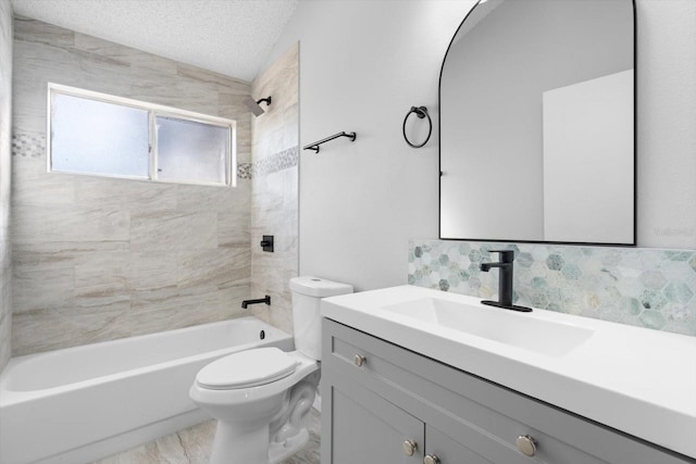 full bathroom with vanity, tiled shower / bath, vaulted ceiling, toilet, and a textured ceiling