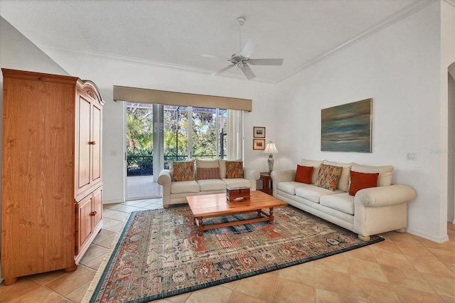 tiled living room with ceiling fan and ornamental molding