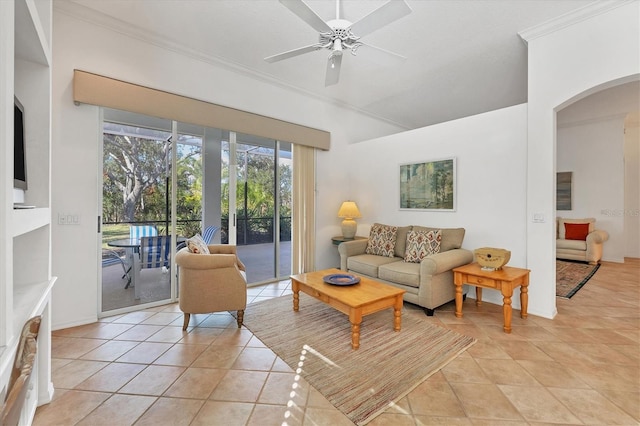 tiled living room with ceiling fan and crown molding