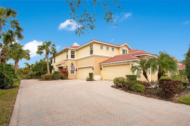 mediterranean / spanish-style home with a garage