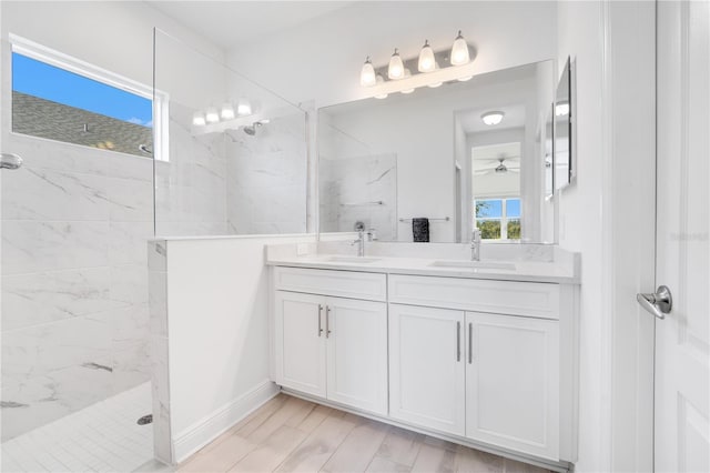 bathroom featuring vanity, ceiling fan, and tiled shower