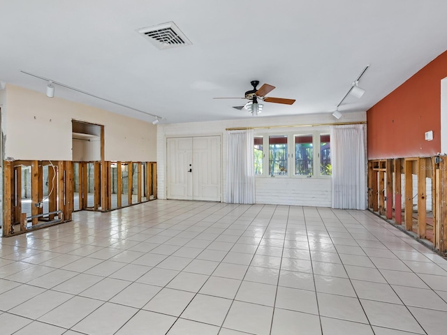 unfurnished room featuring ceiling fan, light tile patterned floors, and rail lighting